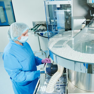 Female worker operating manufacturing equipment to promote Greenfield Risk Solutions Brokers Manufacturing Risks Insurance