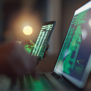 Data on phone and laptop to promote Greenfield Risk Solutions Insurance Brokers - High Risk Niche Insurance - Cyber & Data Risks Insurance