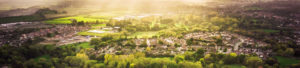 Green landscape surrounding many homes to promote Greenfield Risk Solutions - Property Insurance