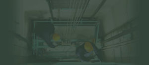 Engineers working on lift to promote Greenfield Risk Solutions Insurance Brokers