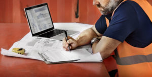 Construction worker working on paperwork to promote Greenfield Risk Solutions Insurance Brokers