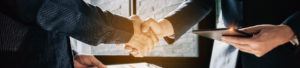 Two office workers shaking hands to promote Greenfield Risk Solutions Insurance Brokers - Financial Lines