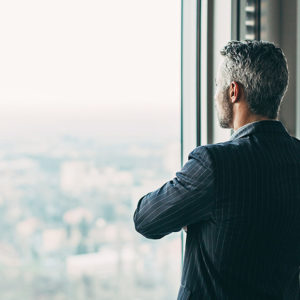 Manager looking out of office window to promote Greenfield Risk Solutions Insurance Brokers - Financial Lines - Directors and Officers D&O Insurance