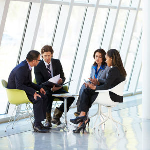 Office workers in conversation to promote Greenfield Risk Solutions Insurance Brokers - Financial Lines - Management Liability Insurance