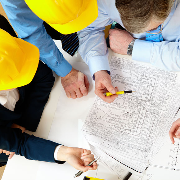 Banner_Products_Financial-Lines_Professional-Indemnity Construction workers leaning over site details to promote Greenfield Risk Solutions Insurance Brokers - Financial Lines - Professional Indemnity Insurance