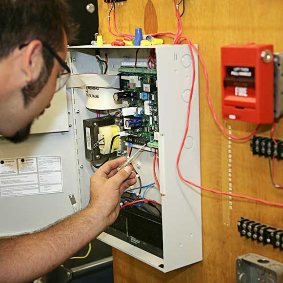 Banner_Construction-Contractors_08_Fire Electrician working on meter to promote Greenfield Risk Solutions Insurance Brokers - Construction and Contractor Insurance - Fire